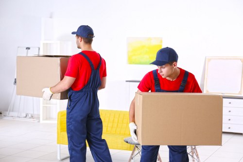 Moving van with recycling boxes and reusable household items in West Kensington
