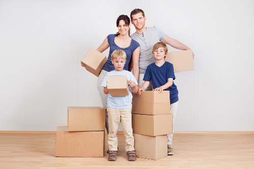 Professional movers preparing furniture for an urgent relocation in West Kensington