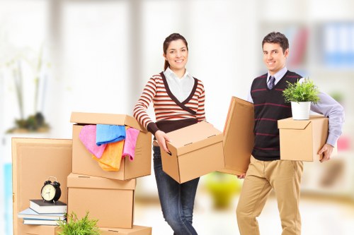 Professional man and van team handling furniture transport in West Kensington