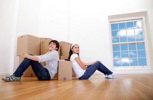 Professional movers handling large furniture in Westkensington
