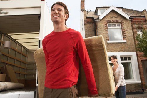 Local removals team loading furniture near West Kensington flats