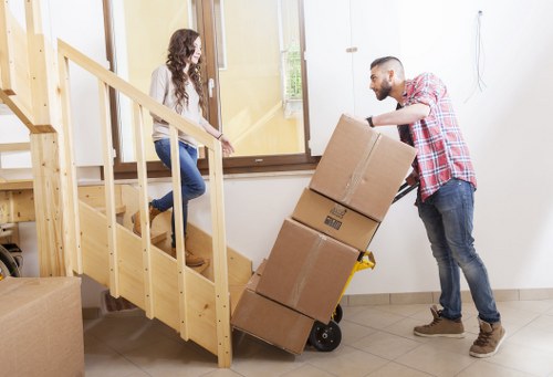 Packing and wrapping household items for a move in West Kensington