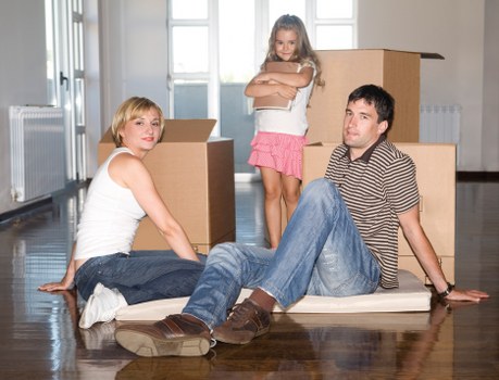 Local removals van helping with packed boxes and furniture
